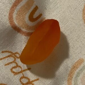 A orange Welch's fruit snack with a red tip